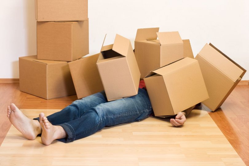 Boxes piled on man