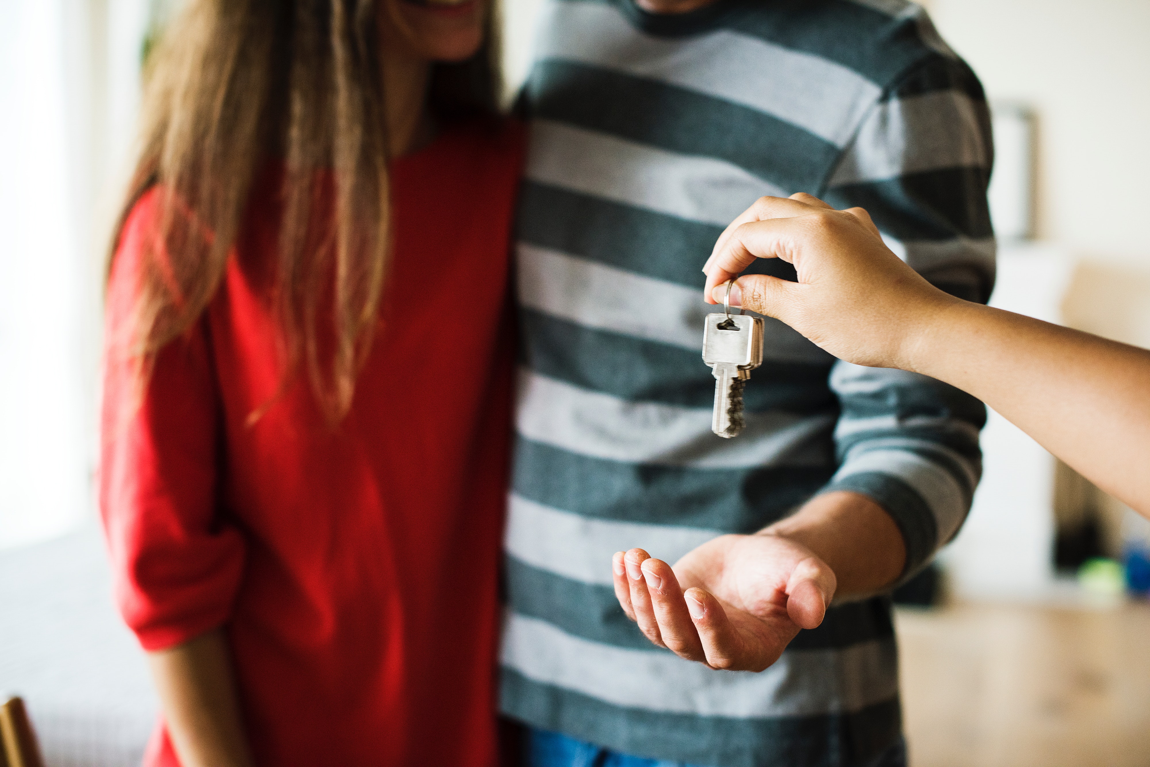 Couple being handed keys